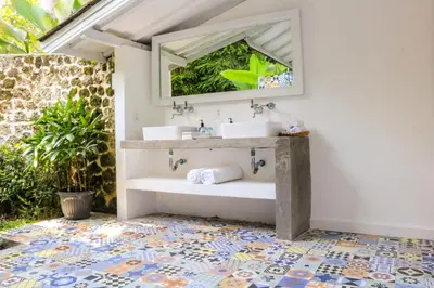 a bathroom with two sinks and a mirror at Chanteak Bali - White House 1 in Jimbaran