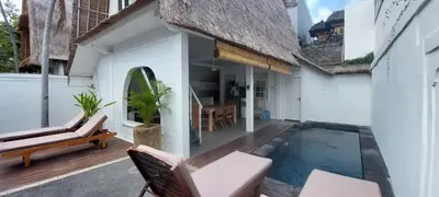 a patio with a swimming pool and a house at Villa Olivia in Seminyak