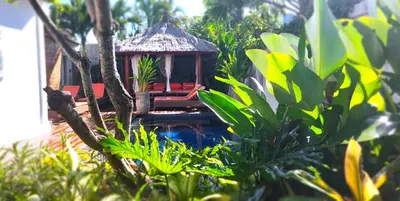 a small house in the middle of a garden at Villa bale villa in Seminyak