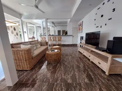 a living room with a couch and a tv at Villa bale villa in Seminyak