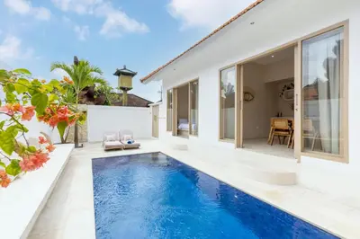a swimming pool in the backyard of a villa at Villa Canggu Beach Coconut - walking distance to Beach & Bars! in Canggu