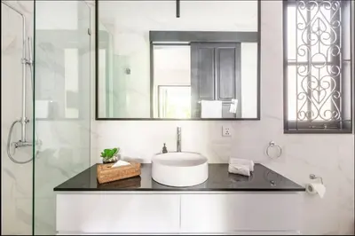 a bathroom with a sink and a mirror at Villa Harris Canggu in Canggu