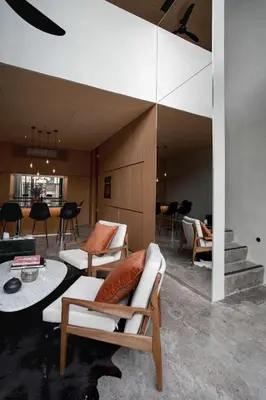 a living room with white chairs and a table at OXO Townhouses Berawa Canggu in Canggu