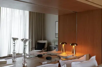 a living room with a table and chairs and a large mirror at OXO Townhouses Berawa Canggu in Canggu