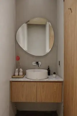 a bathroom with a white sink and a mirror at OXO Townhouses Berawa Canggu in Canggu