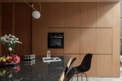 a dining room with a table and chairs and a television at OXO Townhouses Berawa Canggu in Canggu