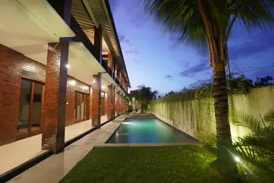 a swimming pool in the middle of a house at Sunkiest House Canggu in Canggu