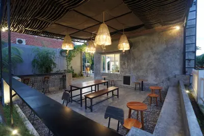 a restaurant with a table and chairs and lights at Sunkiest House Canggu in Canggu