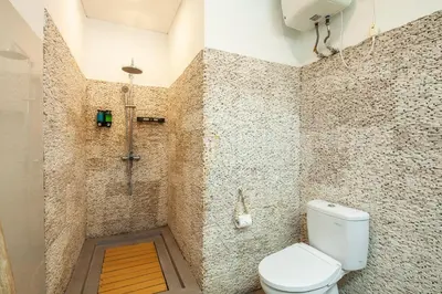 a bathroom with a toilet and a shower at Simple & Magical Villas VILLA SAMBALI in Seminyak