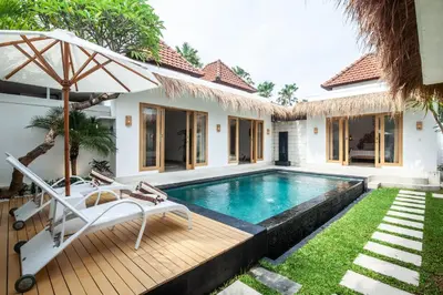 a villa with a swimming pool and a house at Simple & Magical Villas VILLA SAMBALI in Seminyak