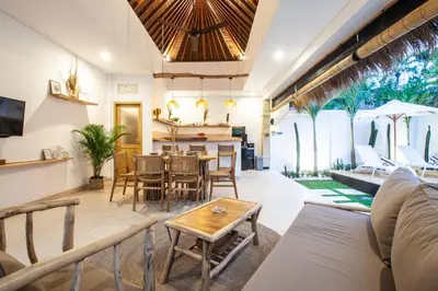 a living room with a couch and a table at Simple & Magical Villas VILLA SAMBALI in Seminyak
