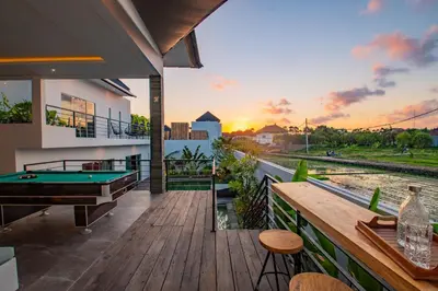 a house with a deck with a pool table at Hedonia Luxury Villas in Seminyak