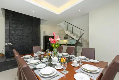 a dining room with a table and chairs at Villa Cascade in Seminyak