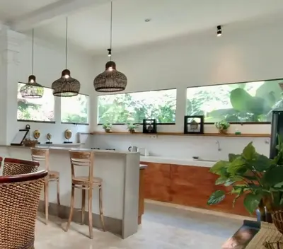 a kitchen with a counter and some stools at Villa MONTI - LEGIAN - SEMINYAK - Lovely 2 Bedroom Villa - Great Location ! in Seminyak