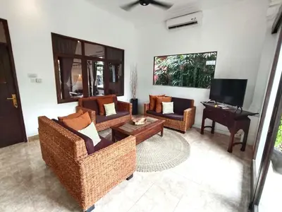 a living room with two couches and a piano at Villa MONTI - LEGIAN - SEMINYAK - Lovely 2 Bedroom Villa - Great Location ! in Seminyak