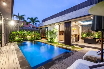an outdoor swimming pool in the backyard of a house at Simple And Magical . VILLA ALMAYA in Seminyak