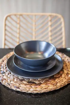 a bowl sitting on a plate on a table at Simple And Magical . VILLA ALMAYA in Seminyak