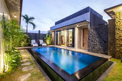 a swimming pool in the backyard of a house at Simple And Magical . VILLA ALMAYA in Seminyak