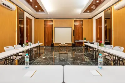 a conference room with tables and a whiteboard at Boss Legian Hotel Powered by Archipelago in Legian