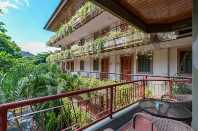 a balcony of a building with a table and chairs at Cozy Bali Apartment in Seminyak