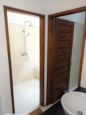 a bathroom with a shower and a toilet and a sink at Villa Tenang Legian in Legian