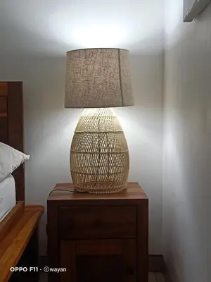 a lamp sitting on a table next to a bed at Villa Tenang Legian in Legian