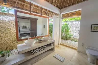 a bathroom with two sinks and a mirror at Istana Semer - Balinese Style Private Event Villa, with Large Pool, Gardens and Cook - Near to Canggu & Seminyak in Kerobokan