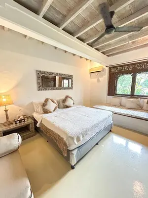 a bedroom with a bed and a couch at Istana Semer - Balinese Style Private Event Villa, with Large Pool, Gardens and Cook - Near to Canggu & Seminyak in Kerobokan