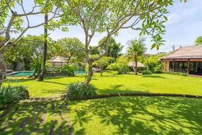 a yard with trees and a house at Istana Semer - Balinese Style Private Event Villa, with Large Pool, Gardens and Cook - Near to Canggu & Seminyak in Kerobokan