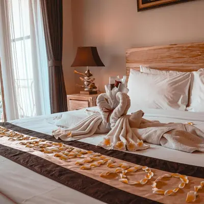a bed with a bunch of food on it at Green D'mel Bali in Nusa Dua