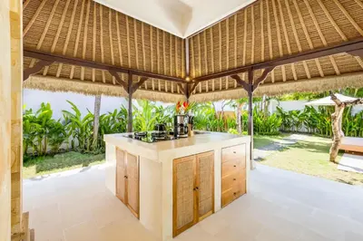 an island in a kitchen with a view of the ocean at Villa Chandika - 4 BDR Villa with private Pool, walk to the beach in Seminyak