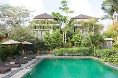 a swimming pool in front of a building at Aqua Octaviana Bali Villa in Canggu