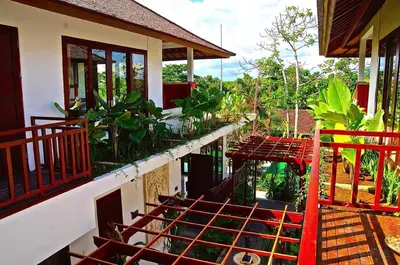 a balcony of a house with a bunch of plants at Aqua Octaviana Bali Villa in Canggu