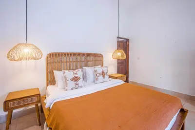 a bedroom with a large bed with two pillows at Villa Deba 2 by Bali Villa Solutions in Seminyak