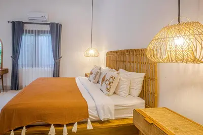 a bedroom with a large bed with white pillows at Villa Deba 2 by Bali Villa Solutions in Seminyak