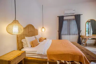 a bedroom with a large bed and a desk at Villa Deba 2 by Bali Villa Solutions in Seminyak