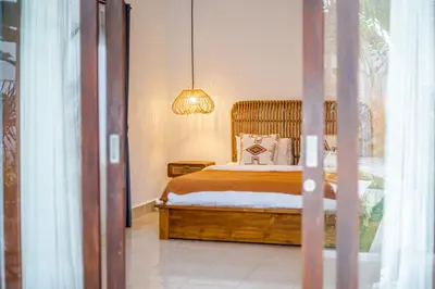 a bedroom with a bed and a chandelier at Villa Deba 2 by Bali Villa Solutions in Seminyak