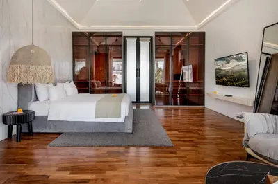 a bedroom with a bed and a living room at Villa Giraffe Seminyak, 4br short walk to Potato Head in Seminyak