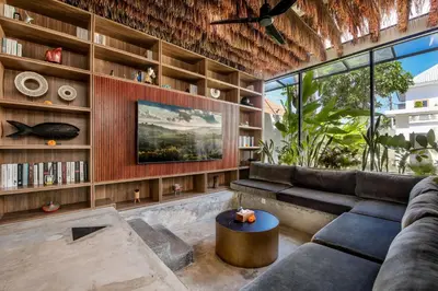 a living room with a couch and a table at Villa Giraffe Seminyak, 4br short walk to Potato Head in Seminyak