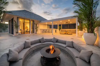 a living room with a couch and a fire pit at Villa Giraffe Seminyak, 4br short walk to Potato Head in Seminyak