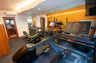 a room with a gym with cardio equipment in it at Natya Hotel Kuta in Kuta