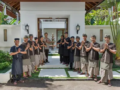 a group of people standing in front of a building at Villa Windu Asri in Seminyak
