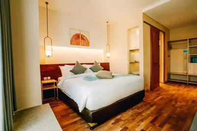 a bedroom with a large bed in a room at Tanaga CoLiving in Seminyak