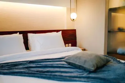 a bedroom with a bed with a pillow on it at Tanaga CoLiving in Seminyak