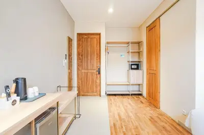 a kitchen with a counter and a refrigerator at Tanaga CoLiving in Seminyak