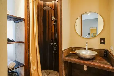 a bathroom with a bowl sink and a mirror at Tanaga CoLiving in Seminyak