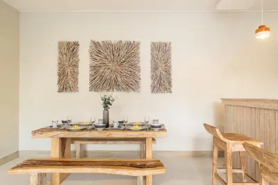 a dining room with a table and two paintings on the wall at ☆ Villa Larissa ☆ Seminyak 2BR Pool Kuta Petitenget in Seminyak