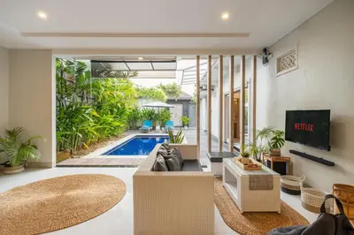 a living room with a couch and a swimming pool at ☆ Villa Larissa ☆ Seminyak 2BR Pool Kuta Petitenget in Seminyak