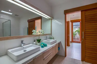 a bathroom with two sinks and a large mirror at Central Seminyak, 3BR, Ensuites, Sleep 6, Peaceful in Seminyak