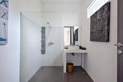 a white bathroom with a sink and a mirror at 3BR Del Mar Beach Villas Near La Plancha Seminyak in Seminyak